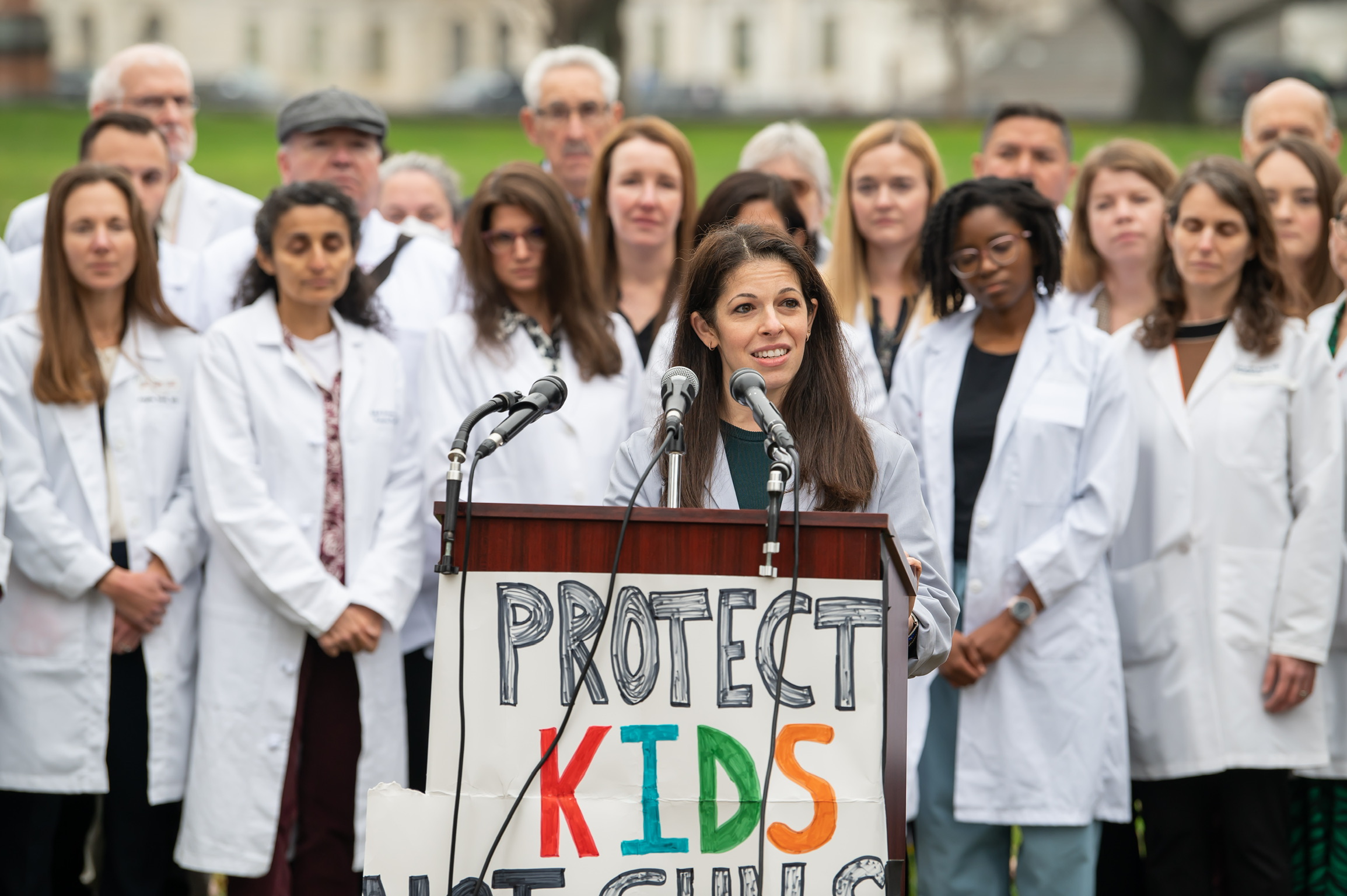 On Call 4 Kids physicians at a press conference holding a Protect Kids sign